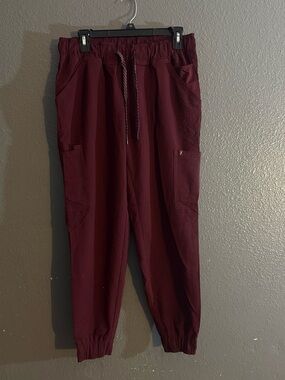 Jaanuu burgundy wine color  women’s scrub bottoms, taper fit